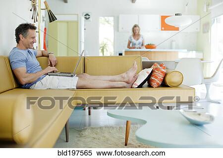 Stock Photography - Couple relaxing at home together. Fotosearch