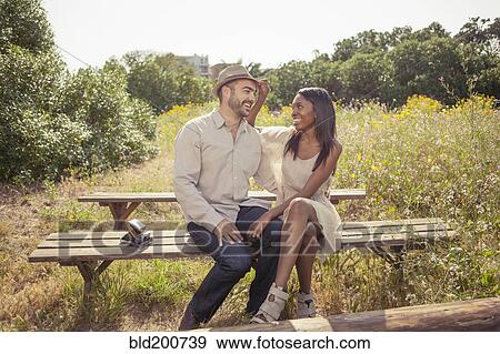 Couple sitting on bench View Large Photo Image Stock Photo - Couple sitting on bench. Fotosearch