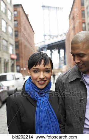 Picture - Couple standing together on city street. Fotosearch