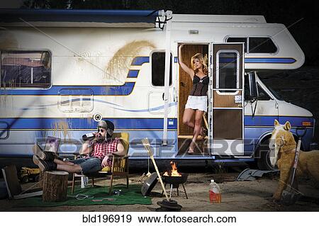 Stock Photo - Couple vacationing in recreational vehicle. Fotosearch