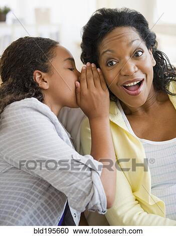 Daughter whispering secret to mother View Large Photo Image Stock Image - Daughter whispering secret to mother. Fotosearch