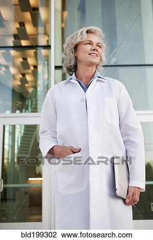 Stock Image - Doctor holding digital tablet outdoors. Fotosearch