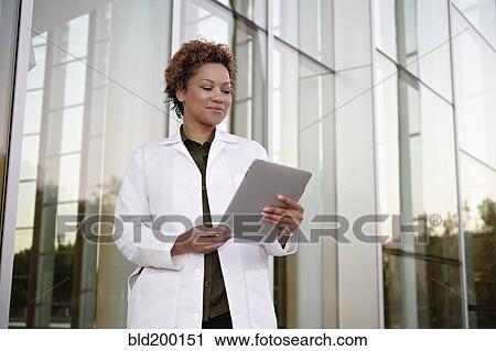 Stock Image - Doctor using digital tablet. Fotosearch