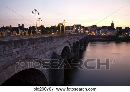 Stock Photo - Dutch canal and bridge at sunset. Fotosearch