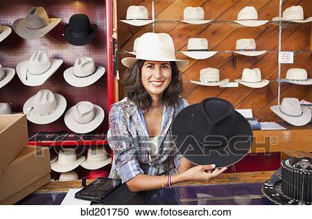Stock Image - Ecuadorian woman selling hats. Fotosearch