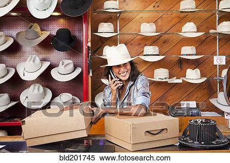 Stock Photography - Ecuadorian woman working in hat store. Fotosearch