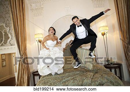Picture - Egyptian bride jumping on bed. Fotosearch