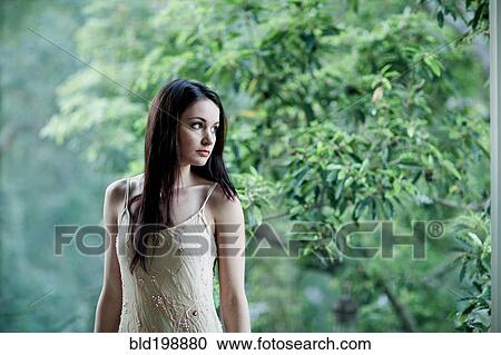 Stock Image - Elegant Caucasian woman standing outdoors. Fotosearch