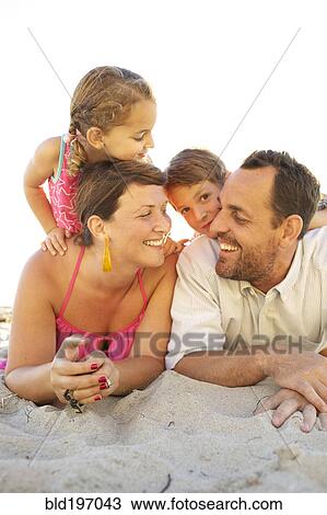 Family laying on beach together View Large Photo Image Stock Image - Family laying on beach together. Fotosearch