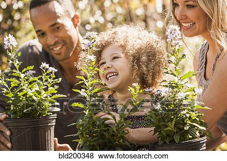 Stock Photo - Family looking at plants. Fotosearch