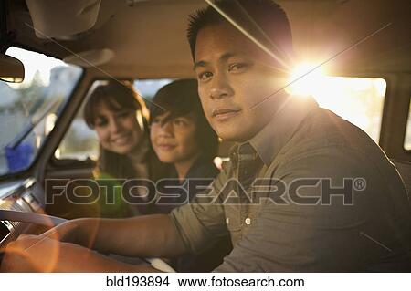Picture - Family riding in van together. Fotosearch