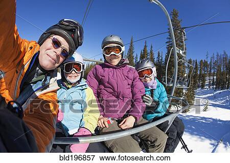 Family riding ski lift together View Large Photo Image Stock Photo - Family riding ski lift together. Fotosearch