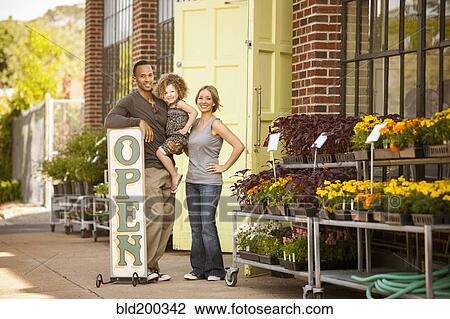 Family standing near florist open sign View Large Photo Image Stock Image - Family standing near florist open sign. Fotosearch