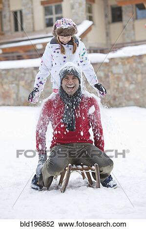 Stock Image - Father and daughter playing in snow. Fotosearch