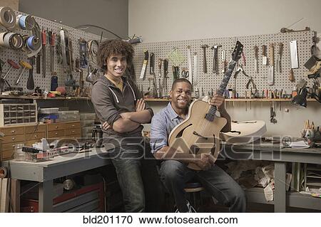 Stock Image - Father and son in music workshop. Fotosearch