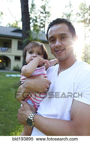 Father holding daughter outdoors View Large Photo Image Stock Photography - Father holding daughter outdoors. Fotosearch