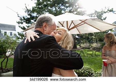 Father hugging his daughter on her wedding day View Large Photo Image Stock Photograph - Father hugging his daughter on her wedding day. Fotosearch