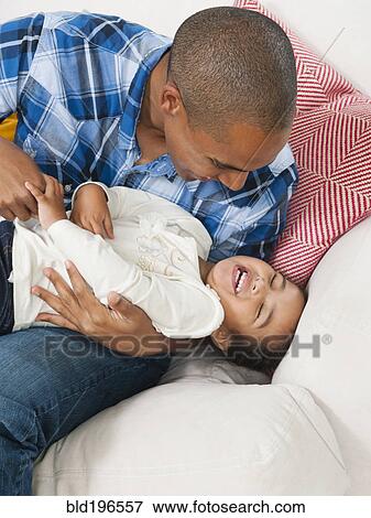 Father tickling daughter View Large Photo Image Stock Photo - Father tickling daughter. Fotosearch