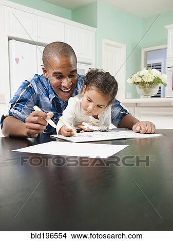 Picture - Father watching his daughter drawing. Fotosearch