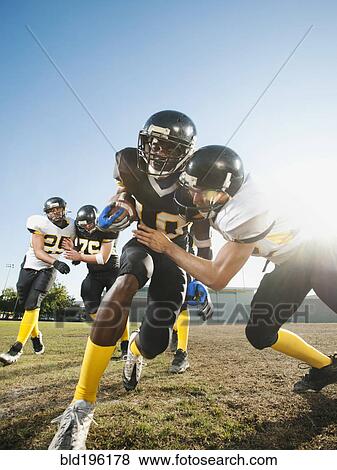 Football player tackling player on football field View Large Photo Image Stock Photo - Football player tackling player on football field. Fotosearch