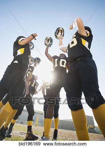 Stock Photo - Football players celebrating on football field. Fotosearch
