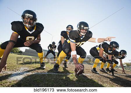 Football players crouching on football field View Large Photo Image Stock Image - Football players crouching on football field. Fotosearch
