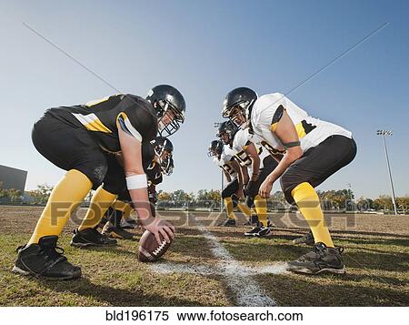 Stock Photography - Football players crouching on football field. Fotosearch