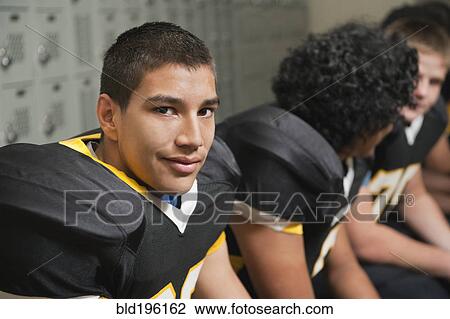 Football players dressing in locker room View Large Photo Image Stock Image - Football players dressing in locker room. Fotosearch