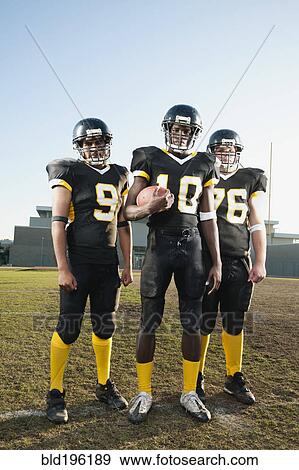 Football players standing on football field View Large Photo Image Stock Photo - Football players standing on football field. Fotosearch