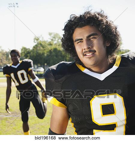 Stock Photo - Football players stretching on football field. Fotosearch
