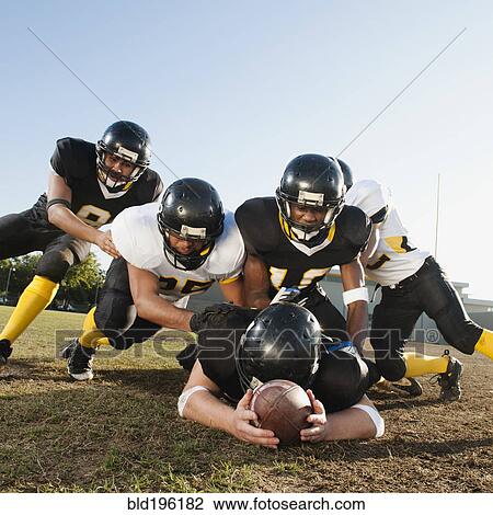 Football players tackling player on football field View Large Photo Image Stock Image - Football players tackling player on football field. Fotosearch