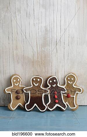 Stock Image - Four gingerbread man cookies in a row. Fotosearch