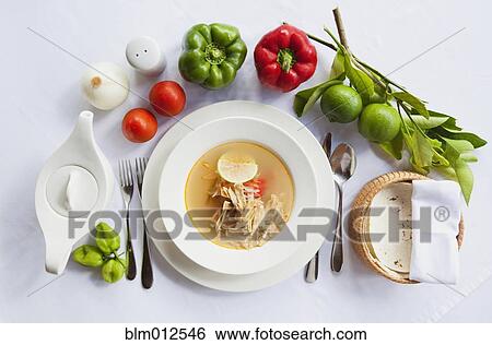Stock Photograph - Fresh vegetables next to sopa de lima. Fotosearch