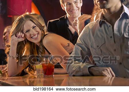 Picture - Friends drinking in nightclub. Fotosearch