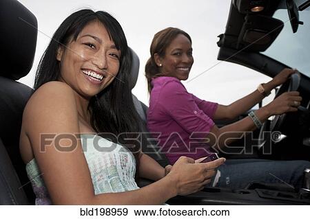Friends driving in convertible View Large Photo Image Stock Photo - Friends driving in convertible. Fotosearch