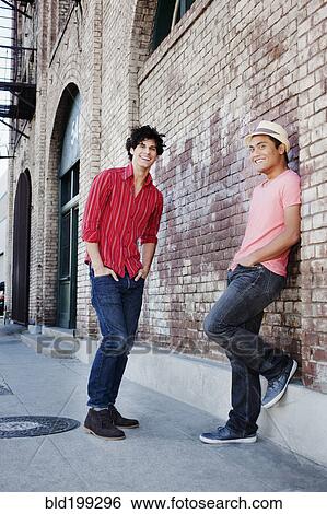 Stock Photograph - Friends hanging out in urban area. Fotosearch