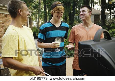Friends hanging out together barbecuing View Large Photo Image Stock Image - Friends hanging out together barbecuing. Fotosearch
