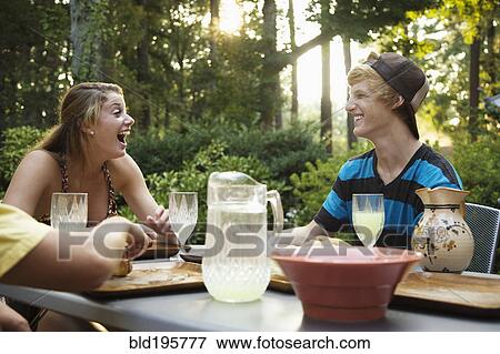 Stock Photo - Friends hanging out together drinking lemonade. Fotosearch