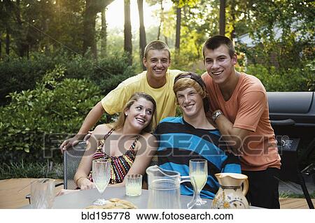 Stock Photo - Friends hanging out together drinking lemonade. Fotosearch