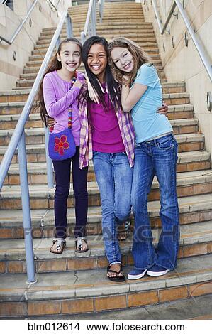 Friends hugging on staircase View Large Photo Image Picture - Friends hugging on staircase. Fotosearch