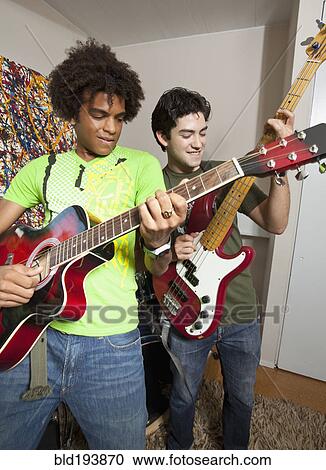 Friends playing guitar together View Large Photo Image Stock Image - Friends playing guitar together. Fotosearch