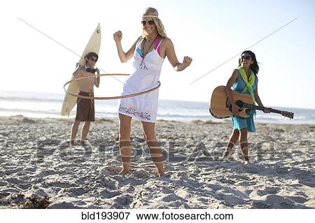 Stock Photo - Friends playing on beach. Fotosearch