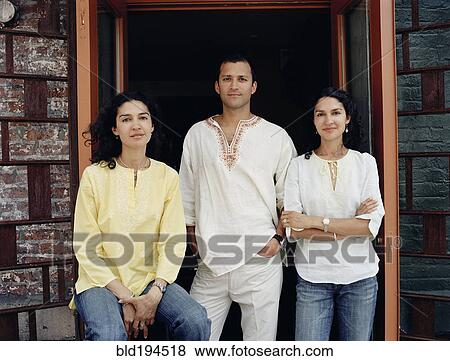 Friends standing in doorway View Large Photo Image Stock Photo - Friends standing in doorway. Fotosearch