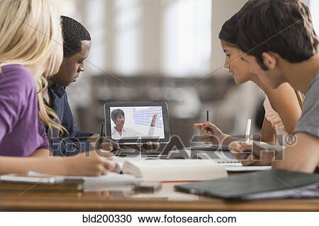 Stock Image - Friends studying with digital tablet. Fotosearch