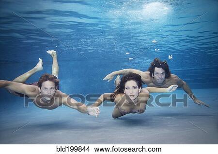 Friends swimming together under water View Large Photo Image Picture - Friends swimming together under water. Fotosearch