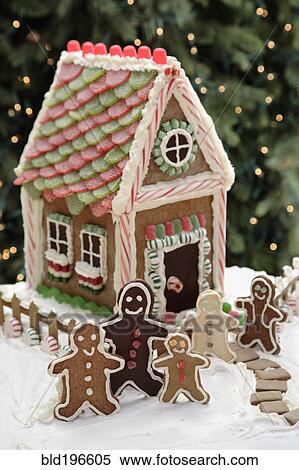 Stock Photography - Gingerbread men cookies and gingerbread house. Fotosearch