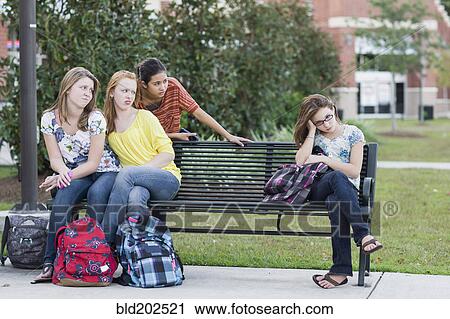 Stock Image - Girl being rejected by other girls. Fotosearch