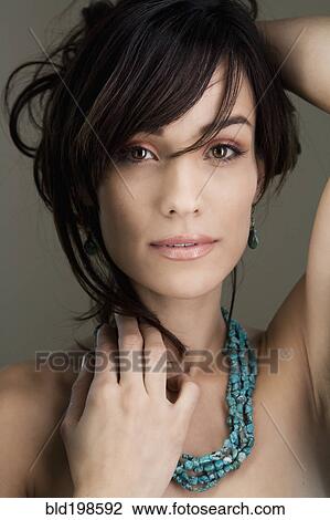 Stock Image - Glamorous woman holding up her hair. Fotosearch