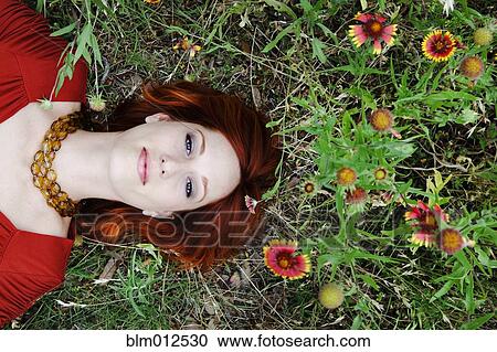 Glamorous woman laying amidst flowers View Large Photo Image Stock Image - Glamorous woman laying amidst flowers. Fotosearch