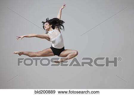 Stock Photo - Graceful Caucasian ballet dancer in mid-air. Fotosearch